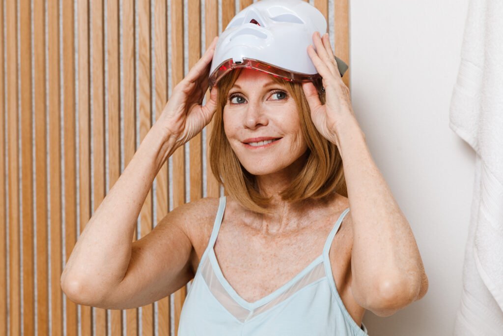 Woman using the Glokore LED Mask at home
